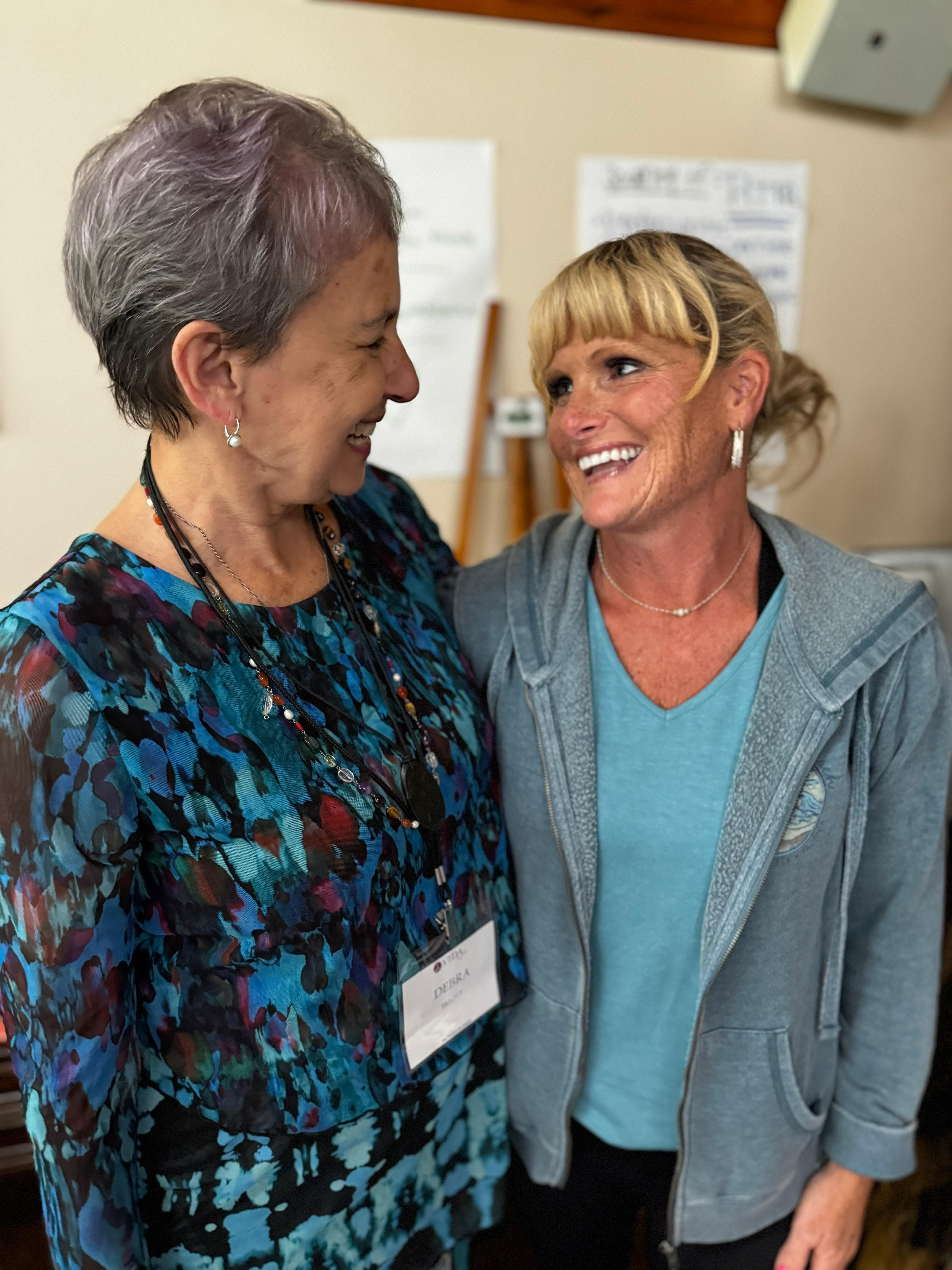 Two friends laughing during a workshop break
